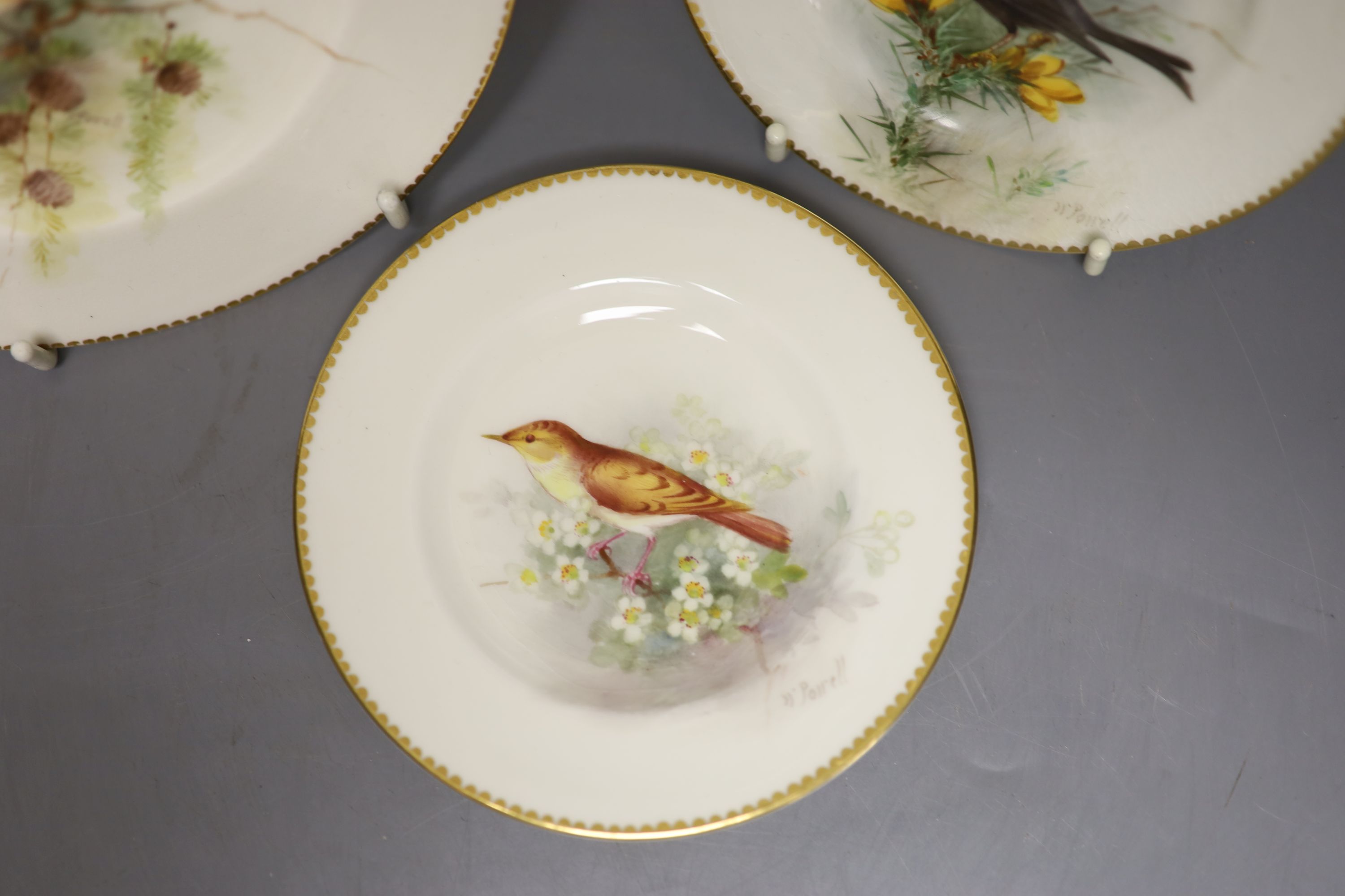 A pair of Royal Worcester plates and a single plate